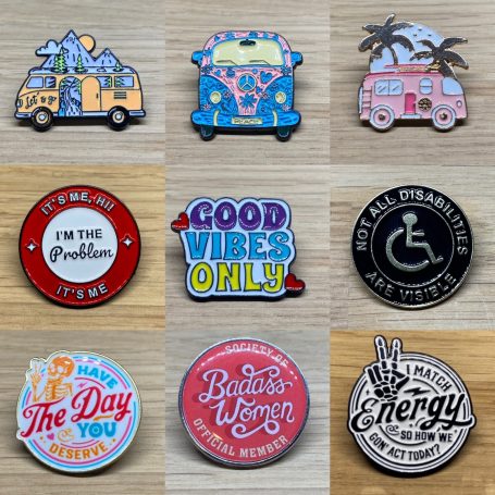 A collection of assorted badges featuring colourful designs and positive messages.